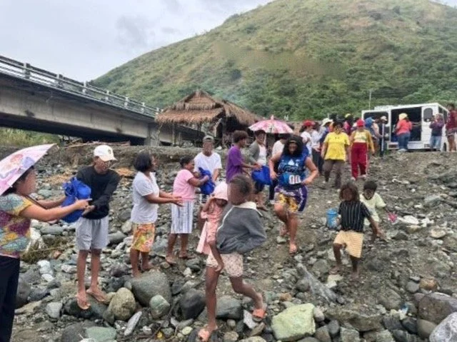 Ako Ang Saklay volunteers distributing aid in a disaster-affected rural community