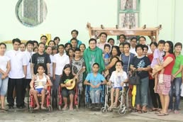 Community group, including people using wheelchairs, gathered in a church